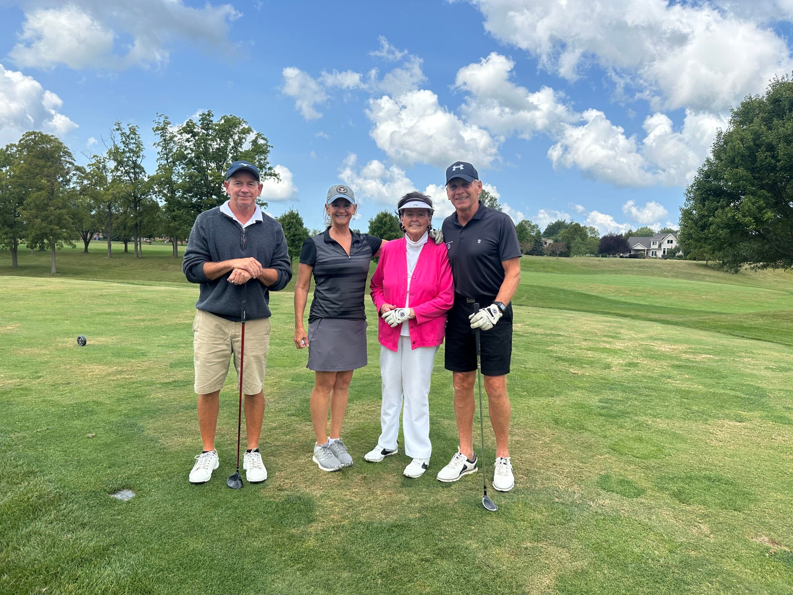 Staff members posing at a golf outing