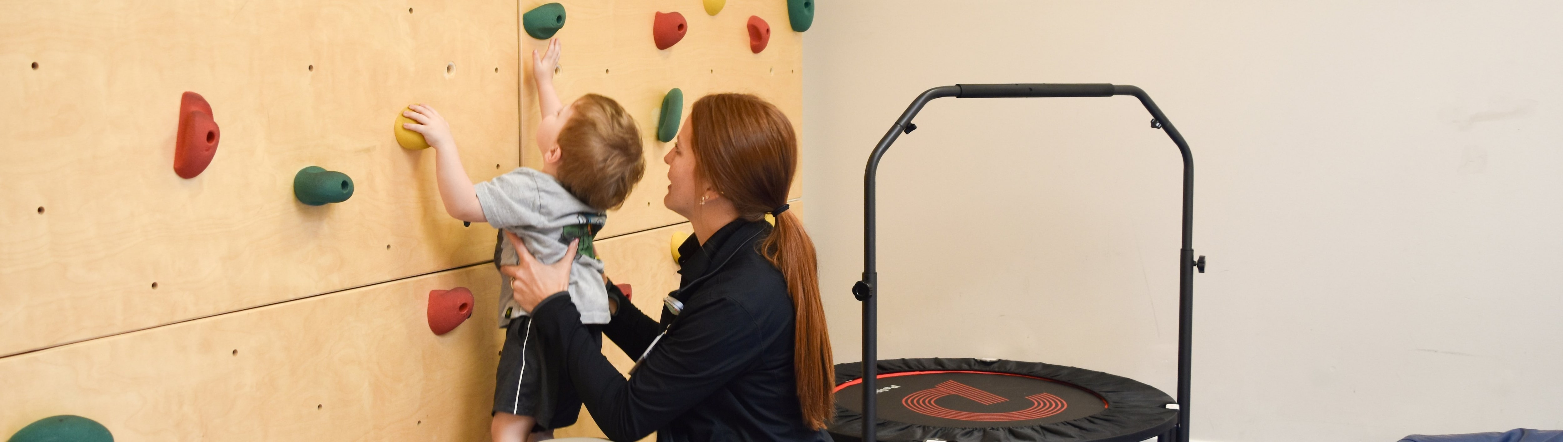 Peds Rock Wall with child and therapist