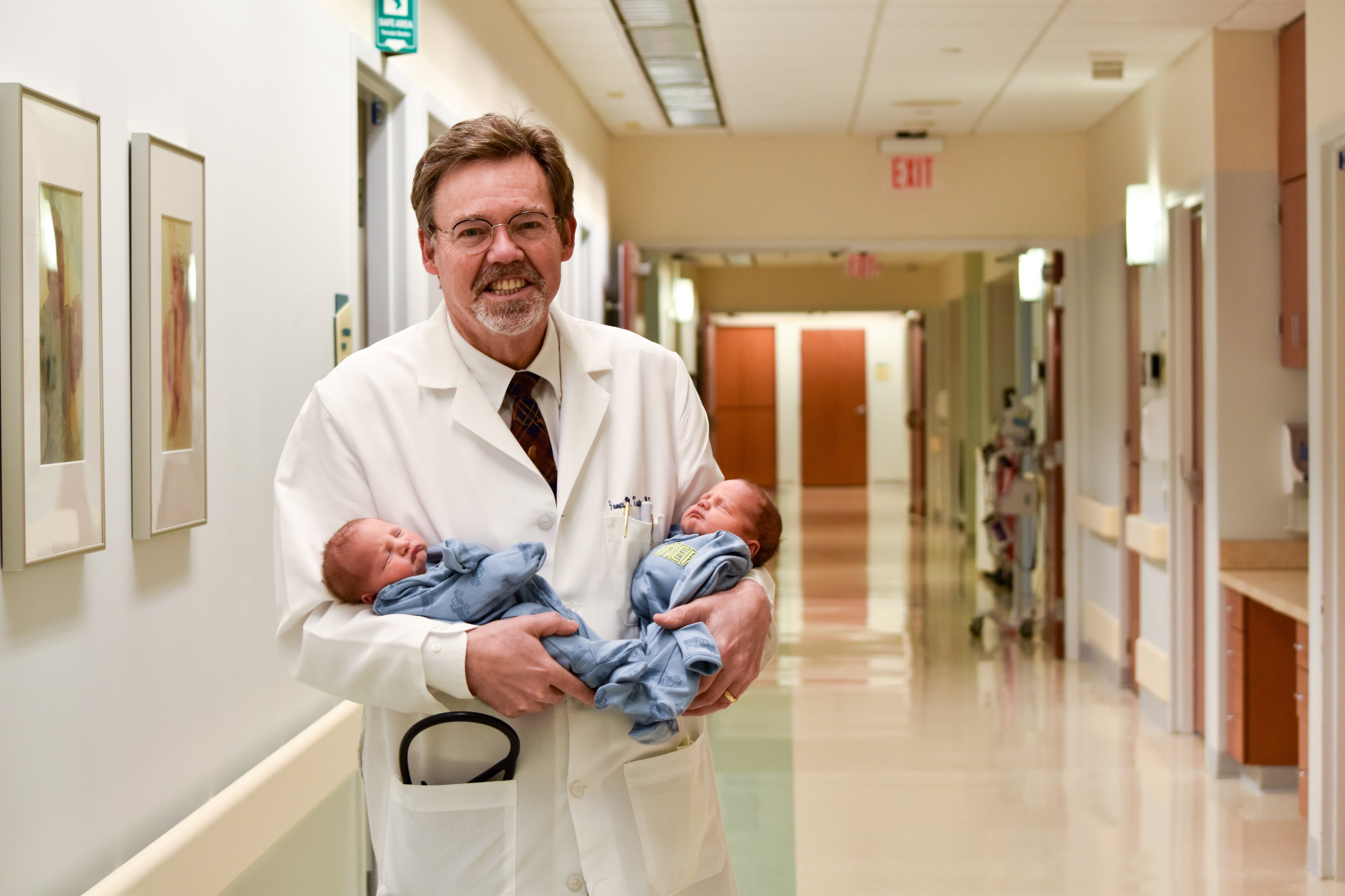 Dr. Kasten poses with babies