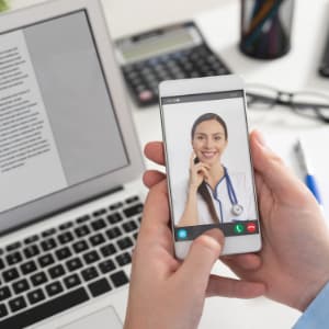 Female physician completing virtual visits.