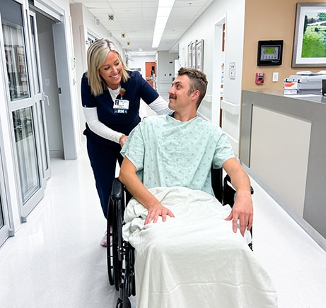 Nurse pushing patient in a wheelchair