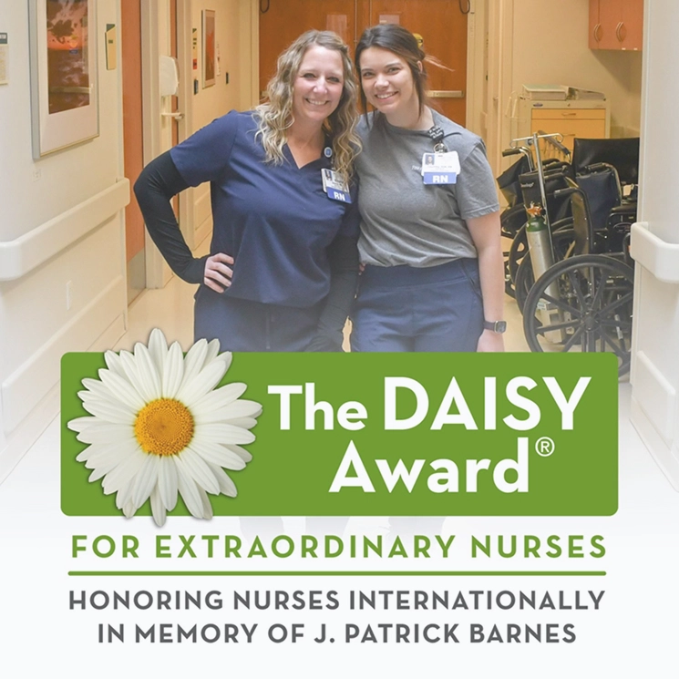 two female nurses posing for a photo.