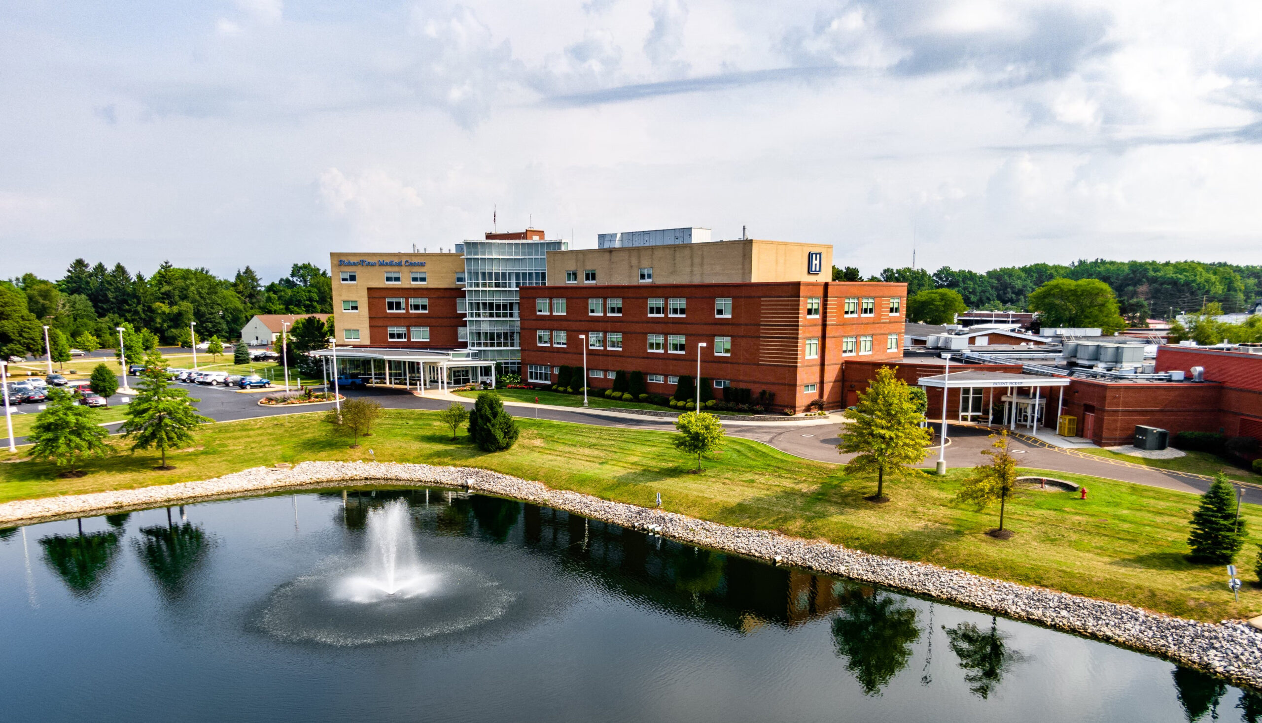 Aerial view of Fisher-Titus Medical Center with fountain pond and green grounds
