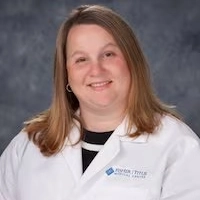 Fisher-Titus provider in white lab coat smiling for professional headshot